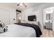 Bright bedroom boasts a bed, dresser with TV, and ensuite bathroom at 5322 N Oro Vista Ct, Litchfield Park, AZ 85340