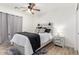 Comfortable bedroom offers a stylish bed, ceiling fan, and sleek decor at 5322 N Oro Vista Ct, Litchfield Park, AZ 85340