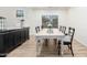 Elegant dining room with a modern table, chairs, and sideboard, perfect for Gathering meals at 5322 N Oro Vista Ct, Litchfield Park, AZ 85340