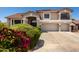 Stately two-story home with a three-car garage, balcony, and mature landscaping at 5322 N Oro Vista Ct, Litchfield Park, AZ 85340