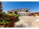Beautiful two-story home with a three-car garage and well-maintained landscaping at 5322 N Oro Vista Ct, Litchfield Park, AZ 85340