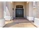 Elegant entryway featuring a double door, decorative lanterns, and a neutral color scheme at 5322 N Oro Vista Ct, Litchfield Park, AZ 85340
