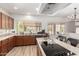 Bright kitchen featuring wood cabinets, granite countertops, a central island, and stainless steel appliances at 5322 N Oro Vista Ct, Litchfield Park, AZ 85340