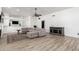 Spacious living room features a large sectional sofa, wood floors, and a modern ceiling fan at 5322 N Oro Vista Ct, Litchfield Park, AZ 85340