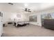 Large primary bedroom with neutral carpet, fan, and two windows at 5322 N Oro Vista Ct, Litchfield Park, AZ 85340