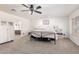 Primary bedroom with natural light, soft carpet, and ensuite bath at 5322 N Oro Vista Ct, Litchfield Park, AZ 85340