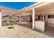 Covered patio with an outdoor kitchen and ample seating area for entertaining guests at 5322 N Oro Vista Ct, Litchfield Park, AZ 85340
