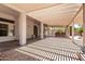 Large covered patio with tile floors, columns, pergola, and outdoor furniture at 5322 N Oro Vista Ct, Litchfield Park, AZ 85340