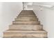 Wooden staircase with white walls and railing leads to the upper level at 5322 N Oro Vista Ct, Litchfield Park, AZ 85340