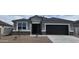 Charming single-story home with a gray exterior, black garage door and front door, and low-maintenance landscaping at 5704 E Smeaton Pl, San Tan Valley, AZ 85140
