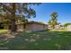 Spacious backyard featuring a brick home with screened patio and mature trees at 6637 W Pershing Ave, Glendale, AZ 85304