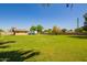 Expansive backyard with lush green grass, mature trees, and an RV parked nearby at 6637 W Pershing Ave, Glendale, AZ 85304