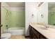 Bathroom with a vintage bathtub, shower, and vanity with marble countertop at 6637 W Pershing Ave, Glendale, AZ 85304