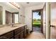 Bathroom featuring a vanity with marble countertop and an open doorway to the yard at 6637 W Pershing Ave, Glendale, AZ 85304