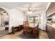 Dining room and eat in kitchen with wooden dining table and large bay window at 6637 W Pershing Ave, Glendale, AZ 85304