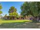 Charming single-story brick home with a well-maintained lawn, mature trees, and inviting curb appeal at 6637 W Pershing Ave, Glendale, AZ 85304