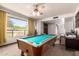 Spacious game room featuring a pool table, ceiling fan, and a large window at 6637 W Pershing Ave, Glendale, AZ 85304