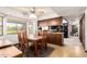 Eat in kitchen space with wooden dining table and view of the backyard through the windows at 6637 W Pershing Ave, Glendale, AZ 85304