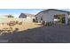 Gravel backyard with block wall, patio furniture and neighboring homes at 7812 W Payson Rd, Phoenix, AZ 85043