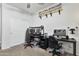 Bright bedroom with two desks, gaming chairs, and decorative shelves with collectibles at 7812 W Payson Rd, Phoenix, AZ 85043
