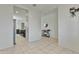 Open hallway view with tile flooring, connecting the kitchen to other living areas at 7812 W Payson Rd, Phoenix, AZ 85043
