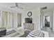 Comfortable living room with tile floor, neutral walls, fan, and natural light from sliding glass door at 7812 W Payson Rd, Phoenix, AZ 85043