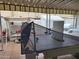 Covered outdoor patio with ping pong table and a cozy seating area at 815 N Hayden Rd # B4, Scottsdale, AZ 85257
