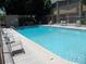 Community pool with lounge chairs and shade structure with table and chairs at 815 N Hayden Rd # B4, Scottsdale, AZ 85257