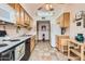 Functional kitchen with tile flooring, light wood cabinets, and classic white appliances at 8241 N Central Ave # 2, Phoenix, AZ 85020