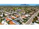 Aerial view showcasing the neighborhood with lush landscaping and mountain views in the distance at 8637 E Via De La Escuela --, Scottsdale, AZ 85258