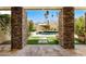 Outdoor living space with stone columns and a view of the pool and landscaped yard at 8637 E Via De La Escuela --, Scottsdale, AZ 85258
