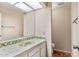 Well-lit bathroom with a tile-lined vanity and sink, mirror, and tile flooring at 8637 E Via De La Escuela --, Scottsdale, AZ 85258