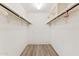Bright, walk-in closet with wood-look flooring and white walls and shelving at 8637 E Via De La Escuela --, Scottsdale, AZ 85258