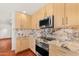Updated kitchen featuring wooden cabinets, granite countertops, and stainless steel appliances at 8637 E Via De La Escuela --, Scottsdale, AZ 85258