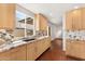 Spacious kitchen with light wood cabinetry, stone countertops, and a sink overlooking the backyard at 8637 E Via De La Escuela --, Scottsdale, AZ 85258