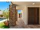 Inviting patio with stone accents, tiled flooring, and a view of the lush landscaping and pool at 8637 E Via De La Escuela --, Scottsdale, AZ 85258