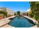 Stunning pool in a private backyard oasis, complete with lush greenery and stone accents at 8637 E Via De La Escuela --, Scottsdale, AZ 85258