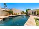 Beautiful backyard pool surrounded by lush landscaping and a stone tile deck at 8637 E Via De La Escuela --, Scottsdale, AZ 85258