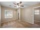 Neutral bedroom features a ceiling fan, a large window, and a sliding door closet at 9233 E Neville Ave # 1125, Mesa, AZ 85209