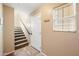 Warm entryway featuring a staircase leading to the upper level and a convenient coat rack by the front door at 9233 E Neville Ave # 1125, Mesa, AZ 85209