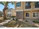 Beautiful townhome featuring stone accents, a well-maintained lawn, and manicured shrubs at 9233 E Neville Ave # 1125, Mesa, AZ 85209