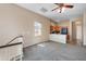 Bright living room and kitchen with neutral tones, ceiling fan, and carpet floors at 9233 E Neville Ave # 1125, Mesa, AZ 85209
