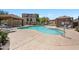 Community pool featuring ample lounge chairs, covered picnic area, and meticulously kept landscaping at 9233 E Neville Ave # 1125, Mesa, AZ 85209