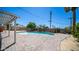 Relaxing backyard with a sparkling pool, covered patio, brick pavers, and a storage shed in back at 1001 W Northern Ave, Phoenix, AZ 85021