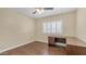 Bedroom featuring hardwood floors, ceiling fan, window with blinds, and a desk in a neutral color palette at 1001 W Northern Ave, Phoenix, AZ 85021