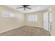 Bedroom featuring neutral carpet, ceiling fan, and two windows for ample natural lighting at 1001 W Northern Ave, Phoenix, AZ 85021
