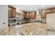Chef's kitchen boasts granite countertops, stainless appliances, and tile backsplash at 1001 W Northern Ave, Phoenix, AZ 85021
