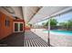 Spacious patio with a pergola, perfect for outdoor entertaining near the pool and backyard shed at 1001 W Northern Ave, Phoenix, AZ 85021