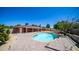 Backyard with an inground pool surrounded by a brick patio and desert landscaping at 1001 W Northern Ave, Phoenix, AZ 85021