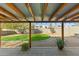 Covered patio leads to a verdant backyard with artificial turf at 1108 E Georgia Ave, Phoenix, AZ 85014